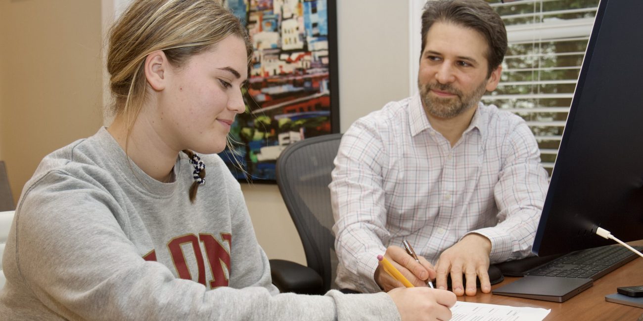 Aron Boxer coaching a high school student in person at his Greenwich office.